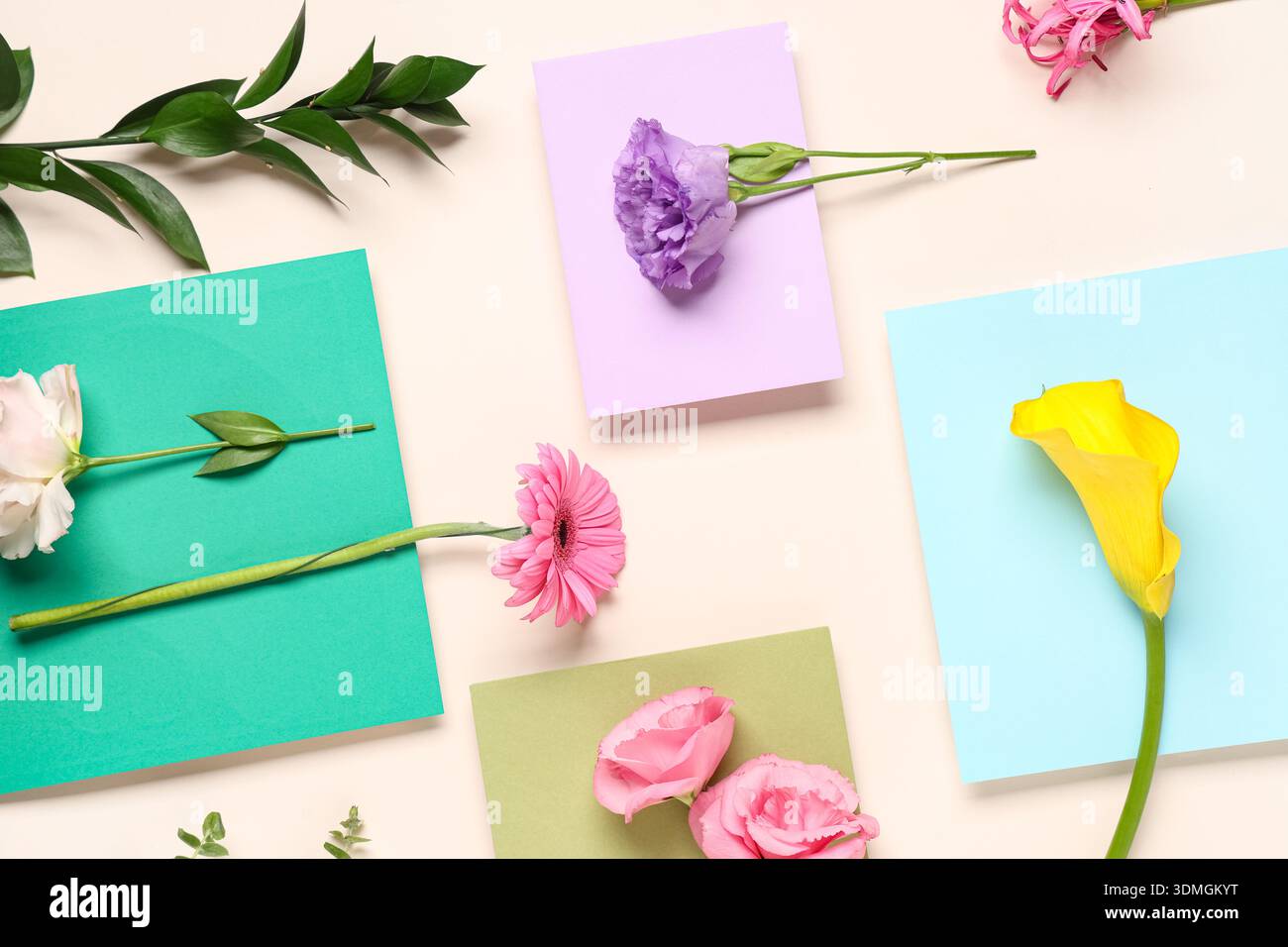 Composition with envelopes and different flowers on beige background Stock Photo