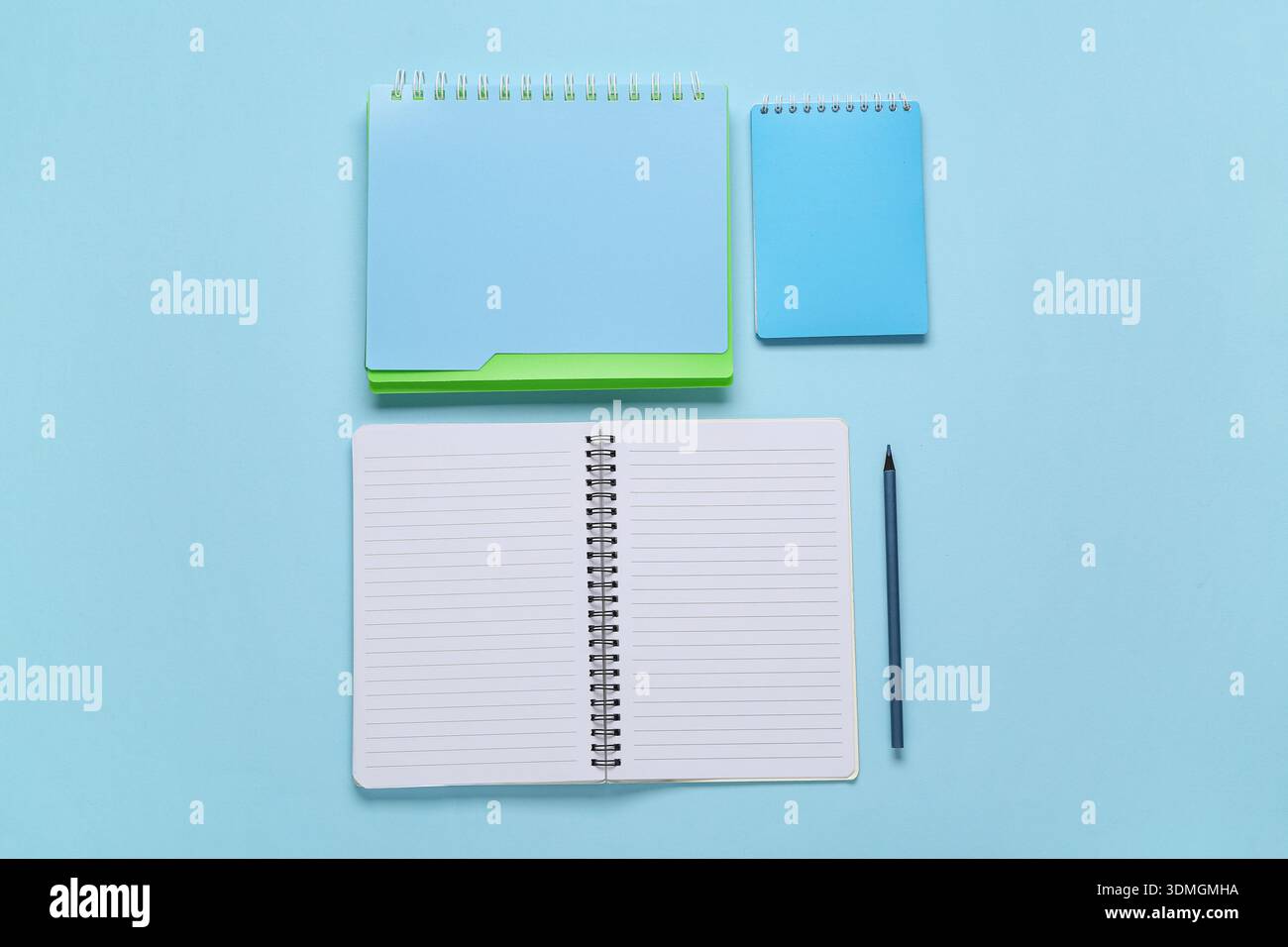Composition with different notebooks on blue background Stock Photo