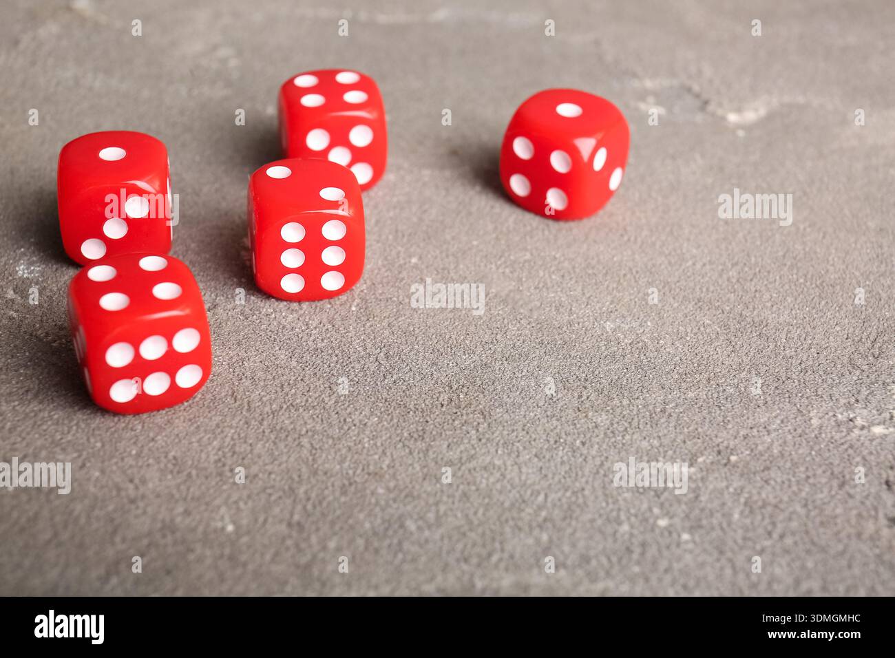 Red dices on grey background Stock Photo