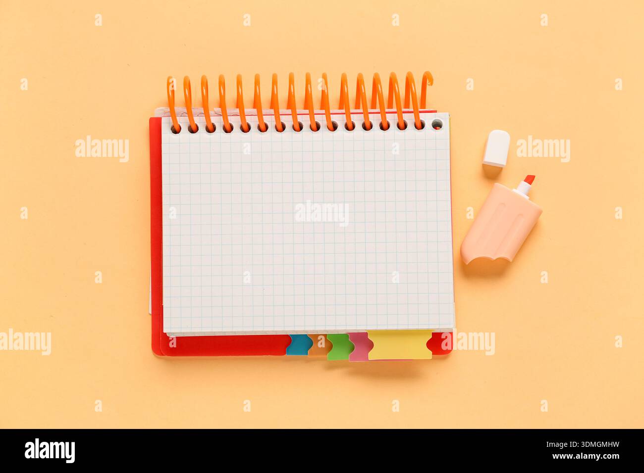 Blank open notebook and felt-tip pen on orange background Stock Photo
