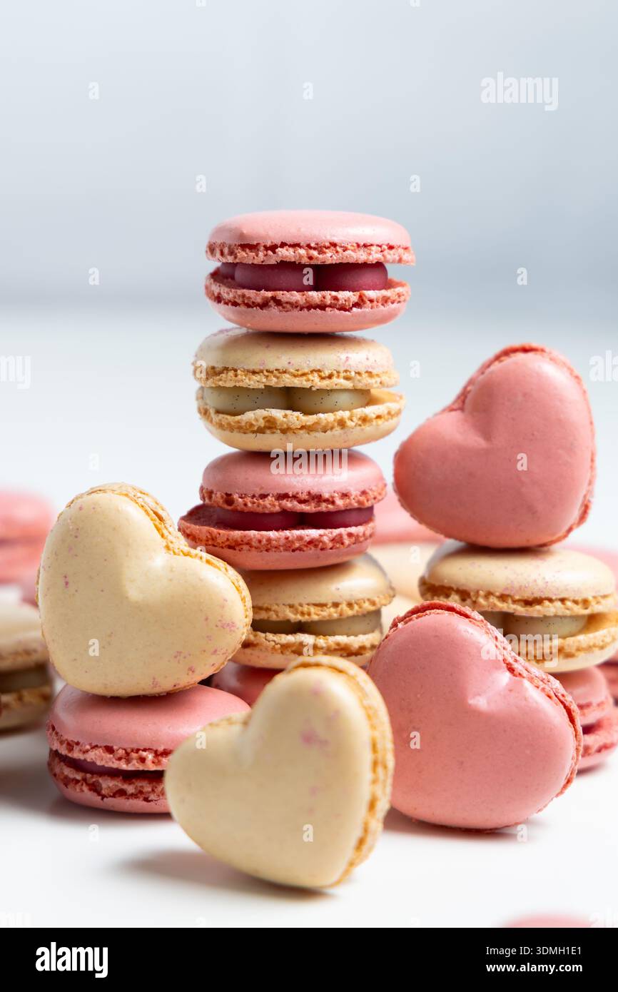 Different types of macarons are arranged on a flat surface. Stock Photo