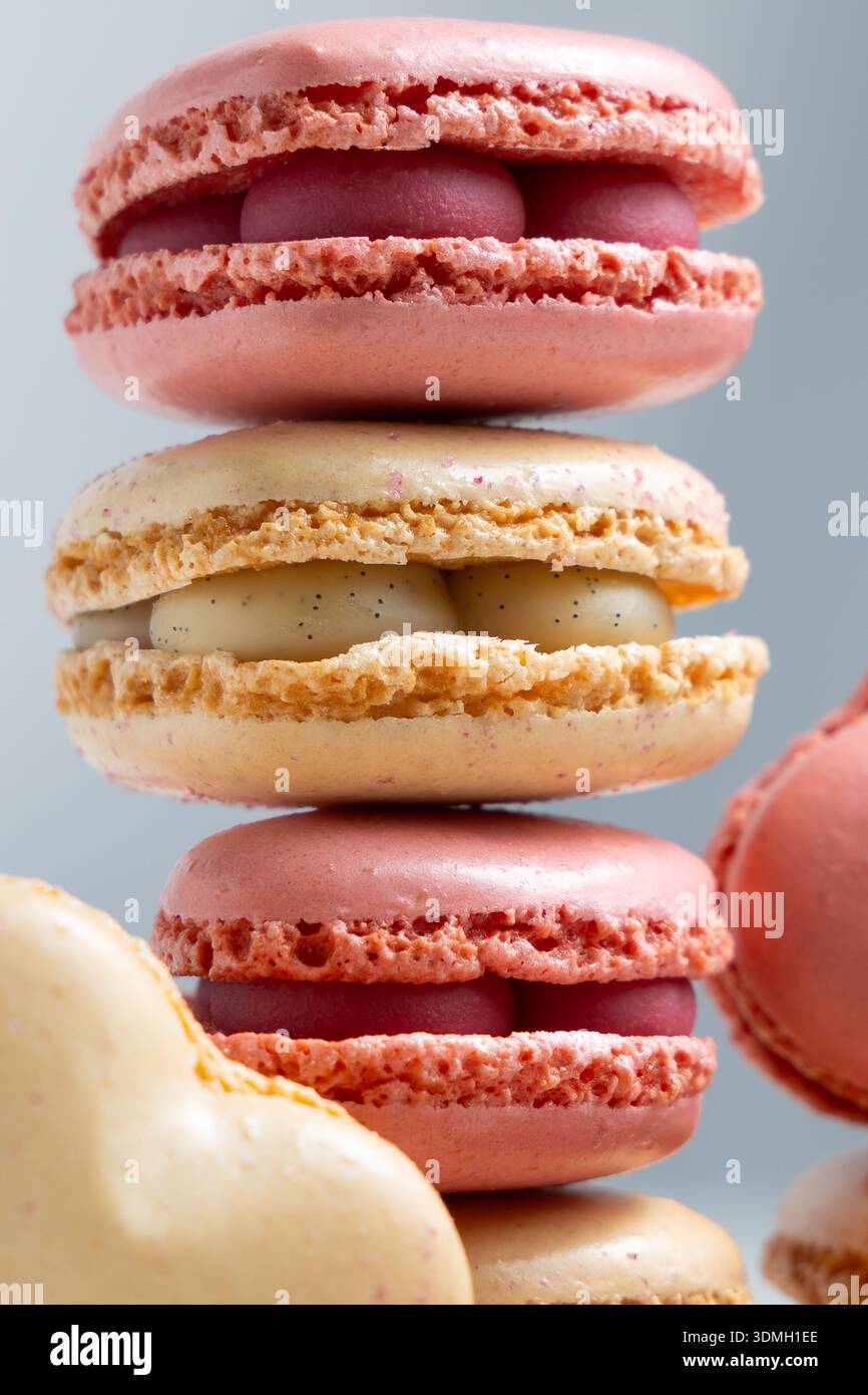 A stack of macarons shows different colors and flavors. Stock Photo