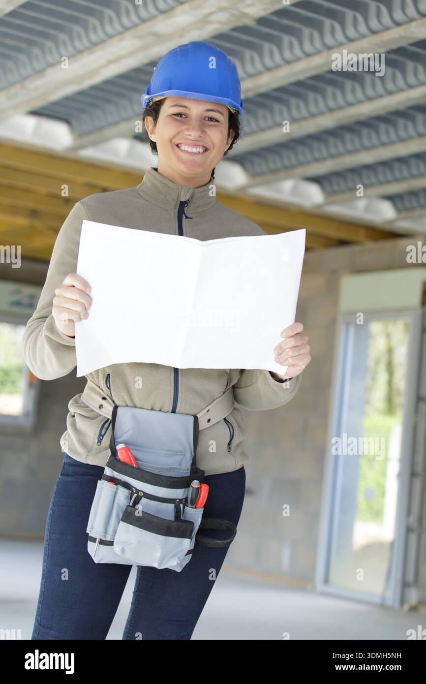 happy builder reading a plan Stock Photo