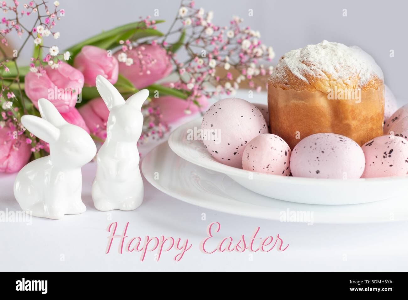 Festive Easter Composition: Kulich Bread, Bunny, Eggs and Floral Decor Stock Photo