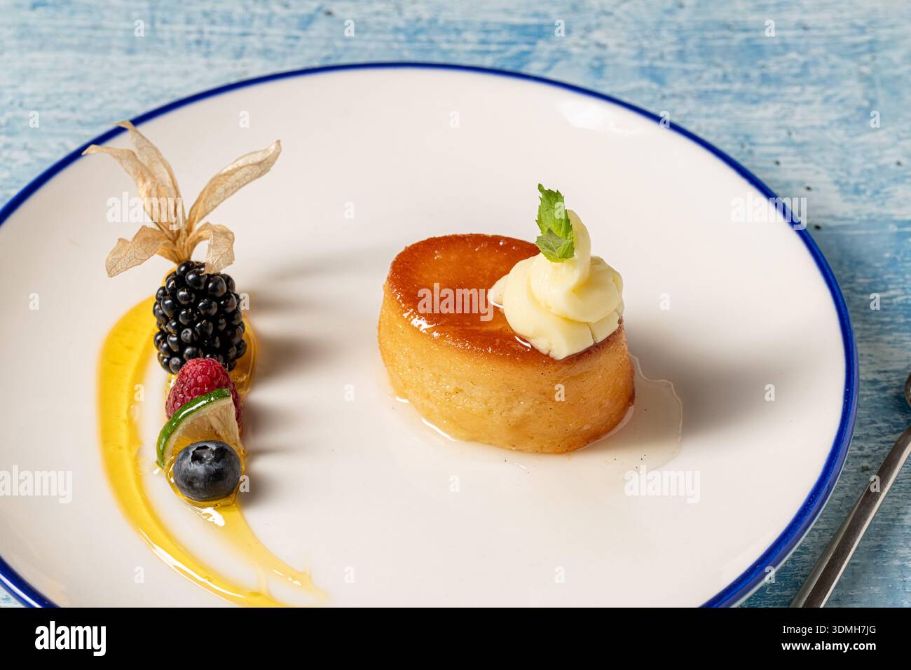 Elegant rom baba dessert with syrup and cream in fine dining presentation Stock Photo