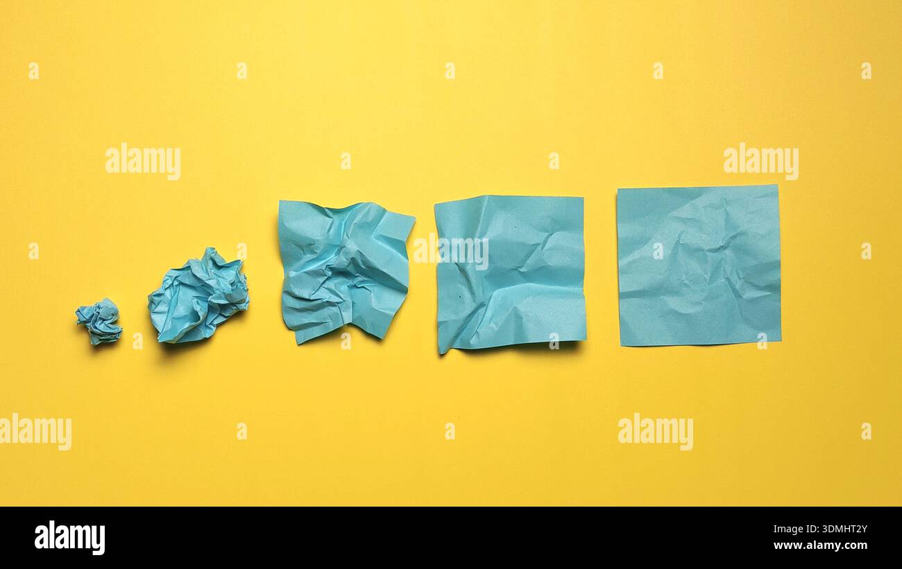 Transformation Process from Crumpled Paper to Smooth Sheet Representing Improvement and Progress Stock Photo