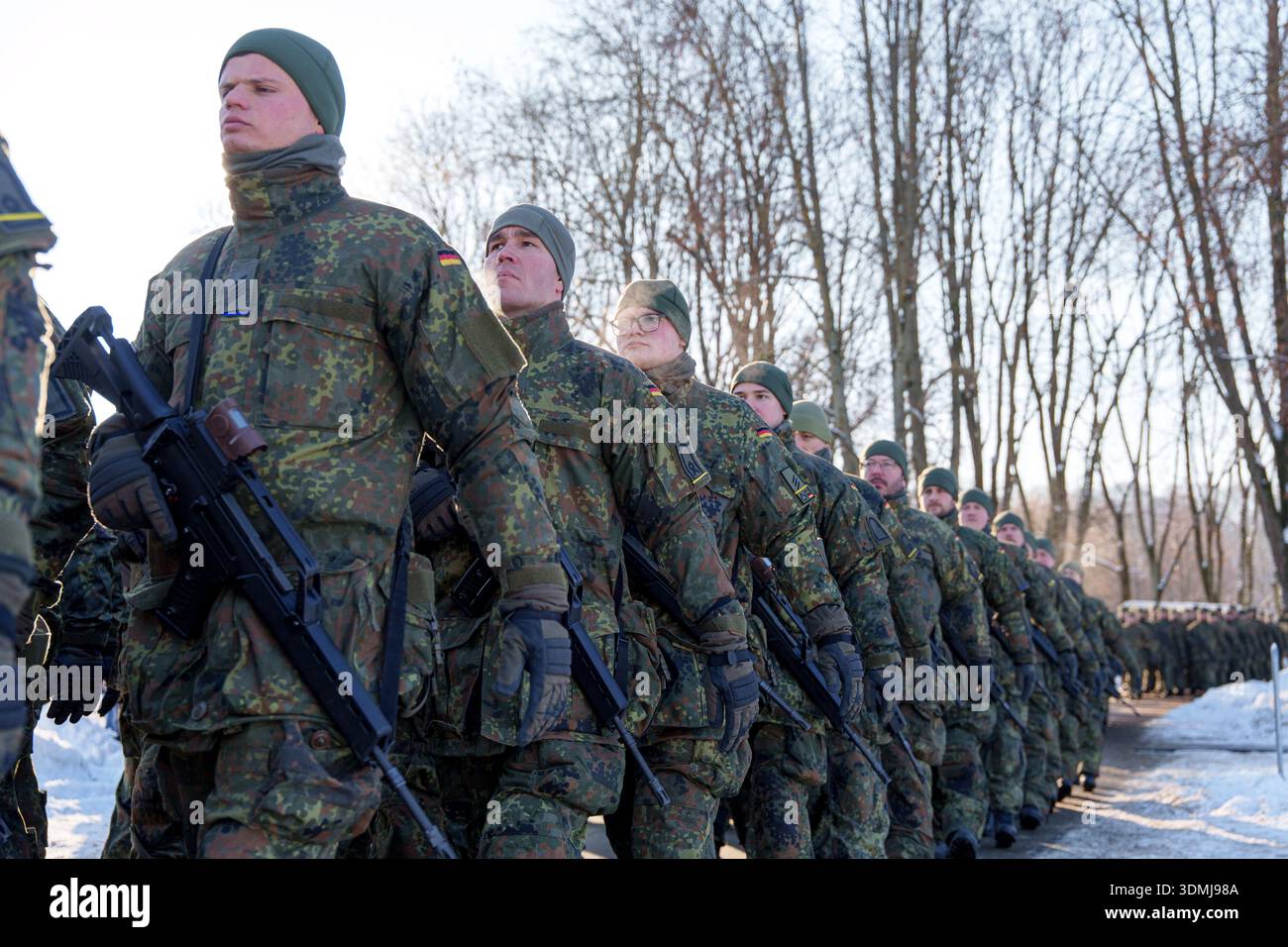 German soldiers in camouflage uniforms marching with rifles during a ...
