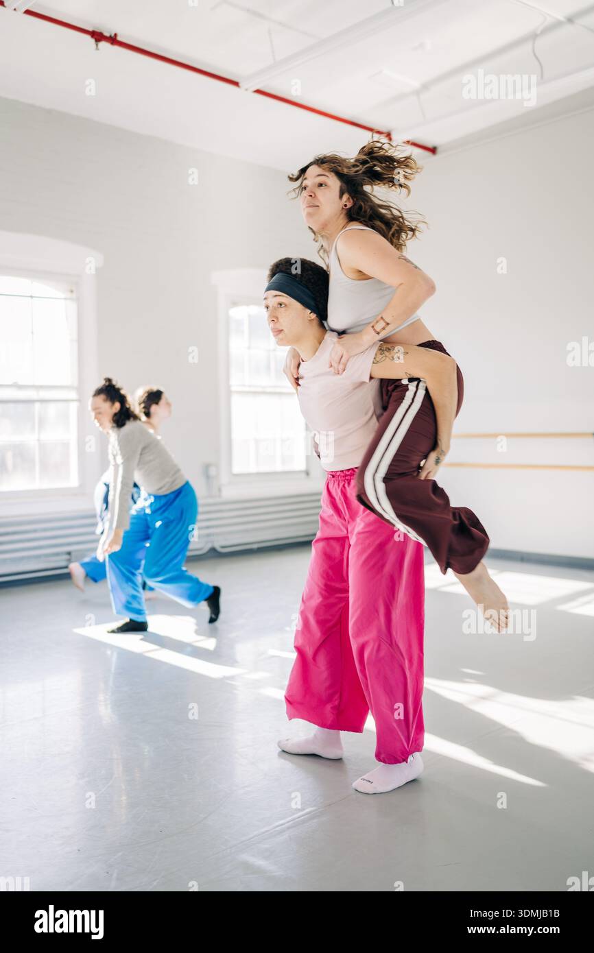 Dancers practicing choreography in modern dance studio Stock Photo