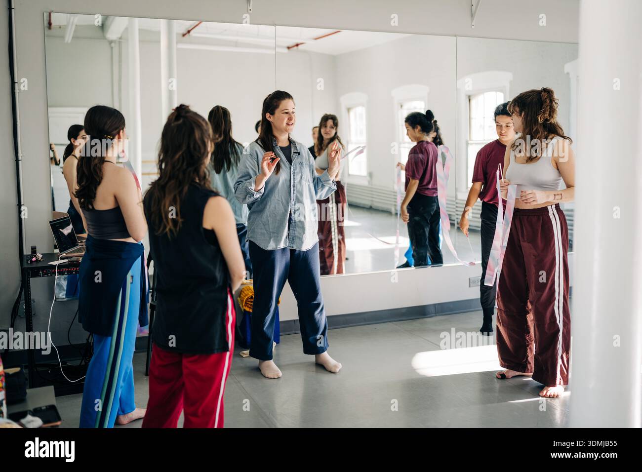 Dance instructor teaching choreography to students in studio Stock Photo