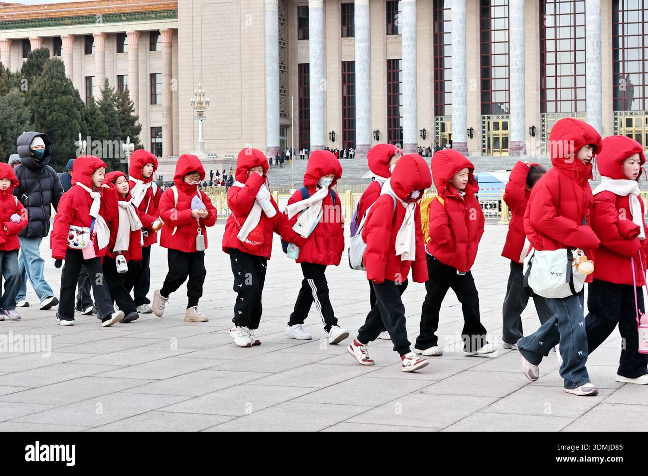 Tourists bundle up against the cold wind while visiting Tiananmen ...