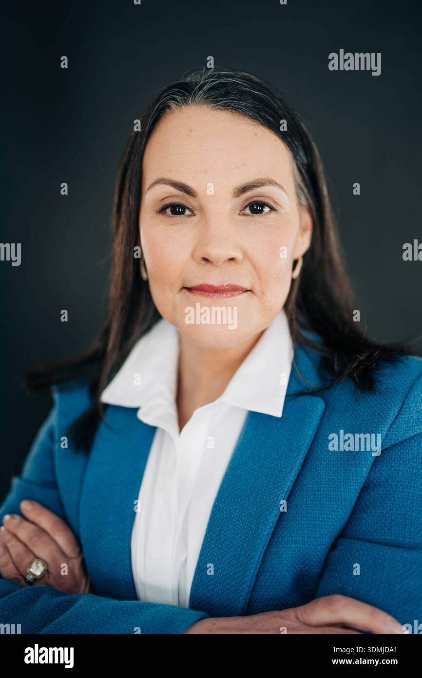Professional woman posing crossing arms looking at camera Stock Photo