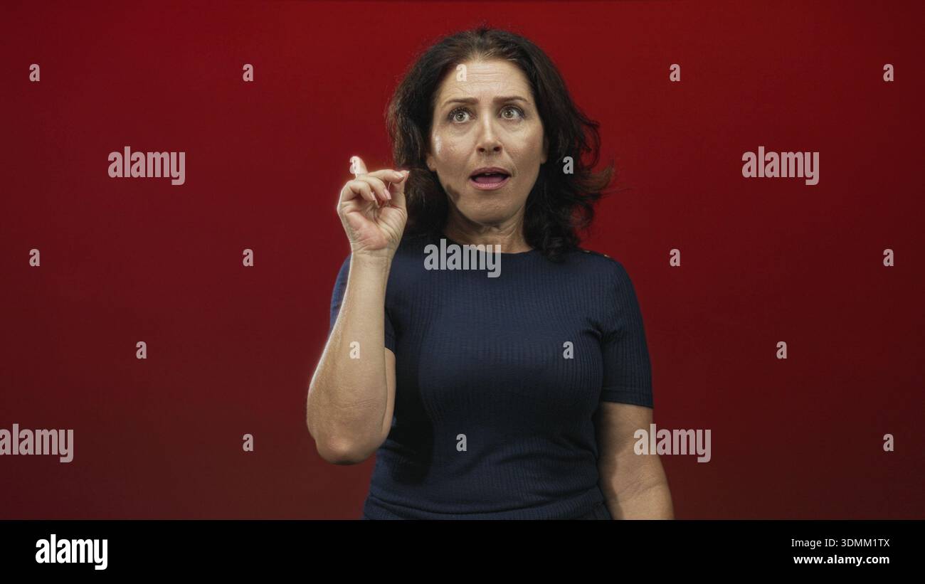 Woman points finger chin indoor hi-res stock photography and images - Alamy