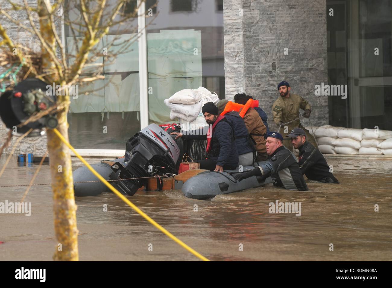 Residents of a hotel are evacuated by police officers and marines by ...