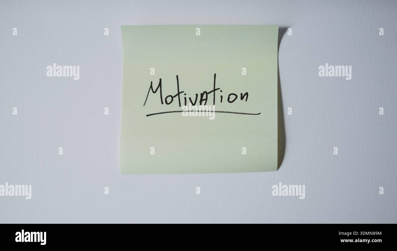 Motivation sticky note on minimal white background Stock Photo