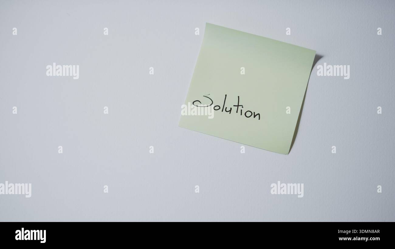 "Solution" Handwritten on Tilted Green Sticky Note — Problem Solving and Business Concept Stock Photo