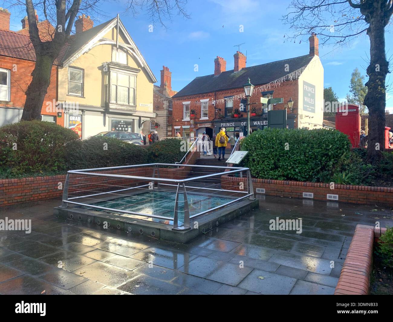 Community members gather in Lincoln of ice sculptures and the Castle walls and the mayor people talking in the street man with a top hat old buildings - Smartphone Captured Stock Image