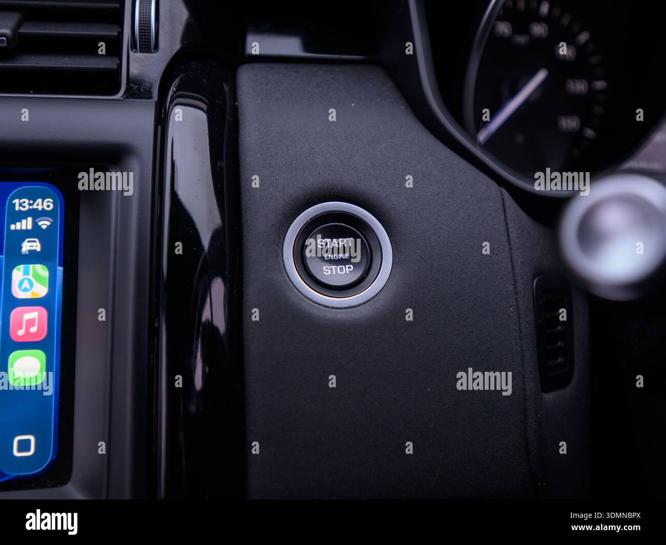 Close up of car engine start stop button on dashboard Stock Photo