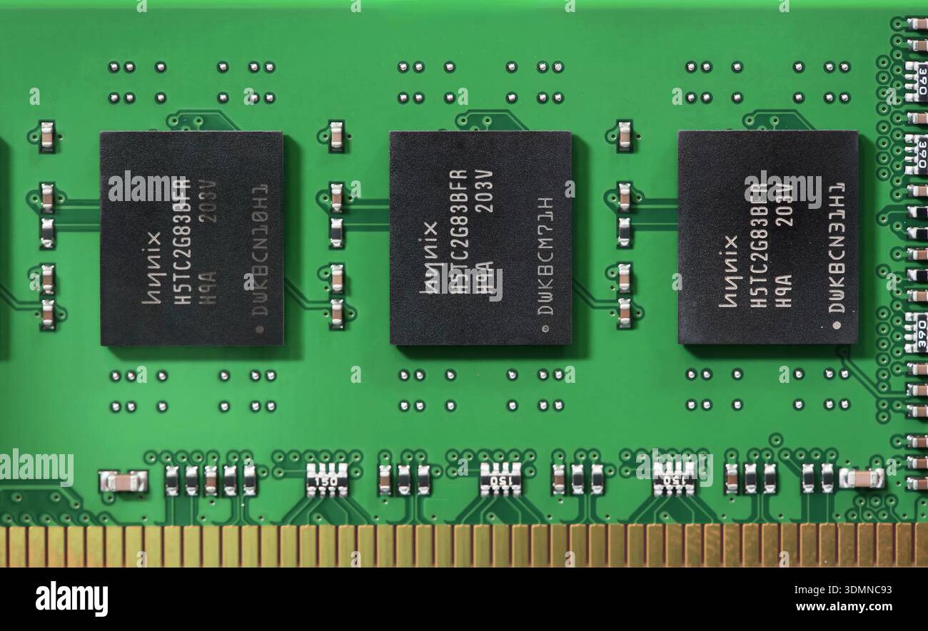 Closeup macro of SK hynix DRAM memory chips on green RAM PCB with gold ...
