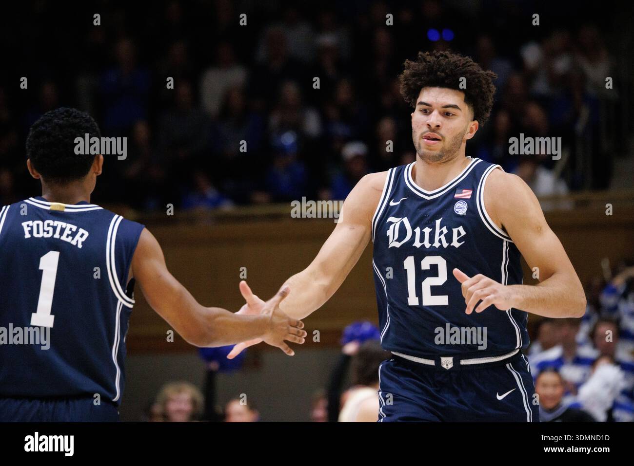 Duke's Cameron Boozer (12) high-fives Caleb Foster (1) during an NCAA ...