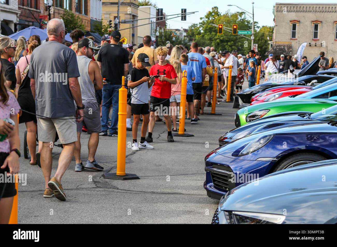 The crowd admires sports cars on display at the Fast and Fabulous car ...