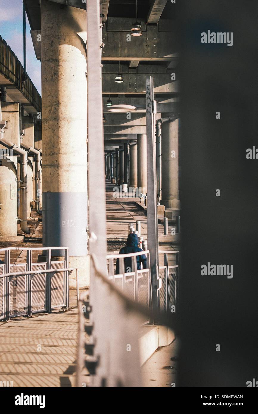 Man is walking next to the bridge in Pittsburgh. Stock Photo