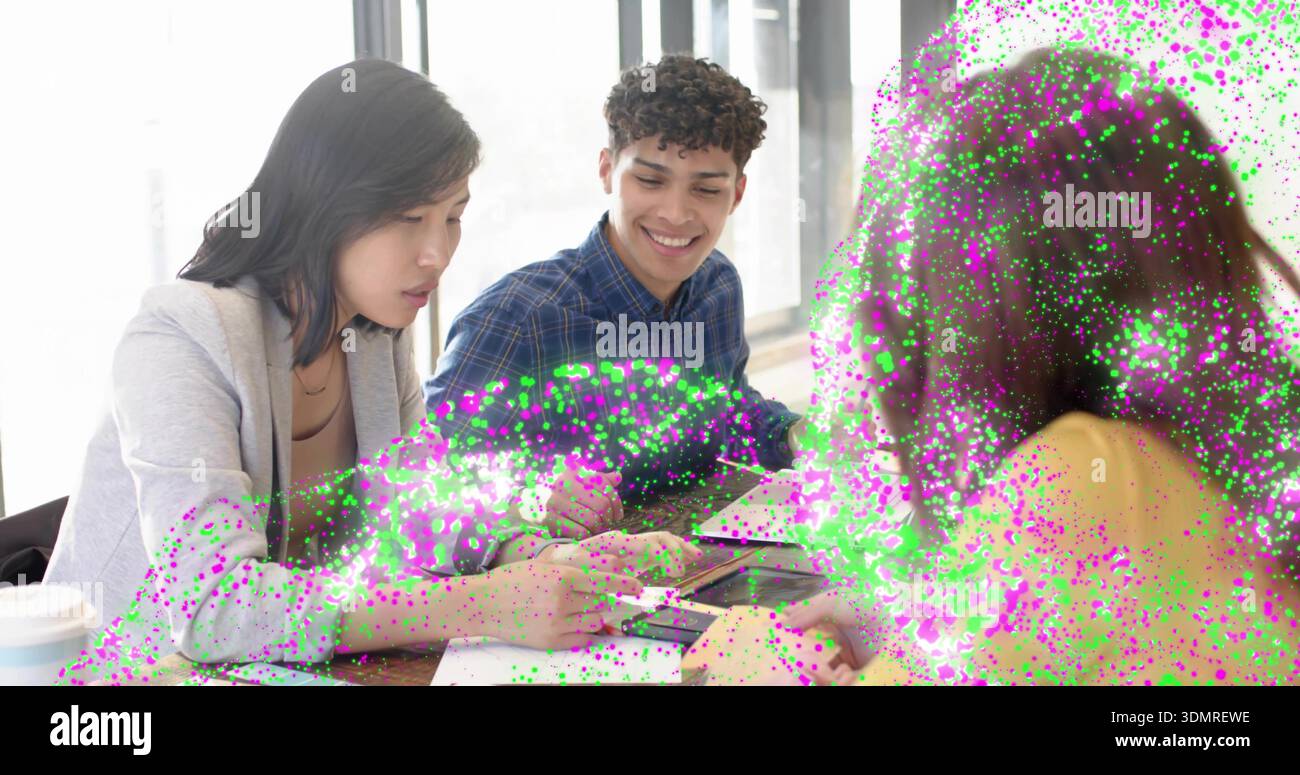 Studying 3 students reviewing papers in study by windows sharing phone speckled overlay in sweater Stock Photo