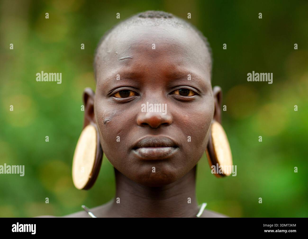 Mursi tribe woman with clay plate in ears, Ari zone, Jinka, Ethiopia ...