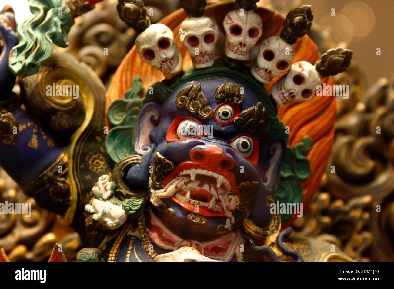 Intricate Sculpture of a Wrathful Deity with Skull Crown Stock Photo