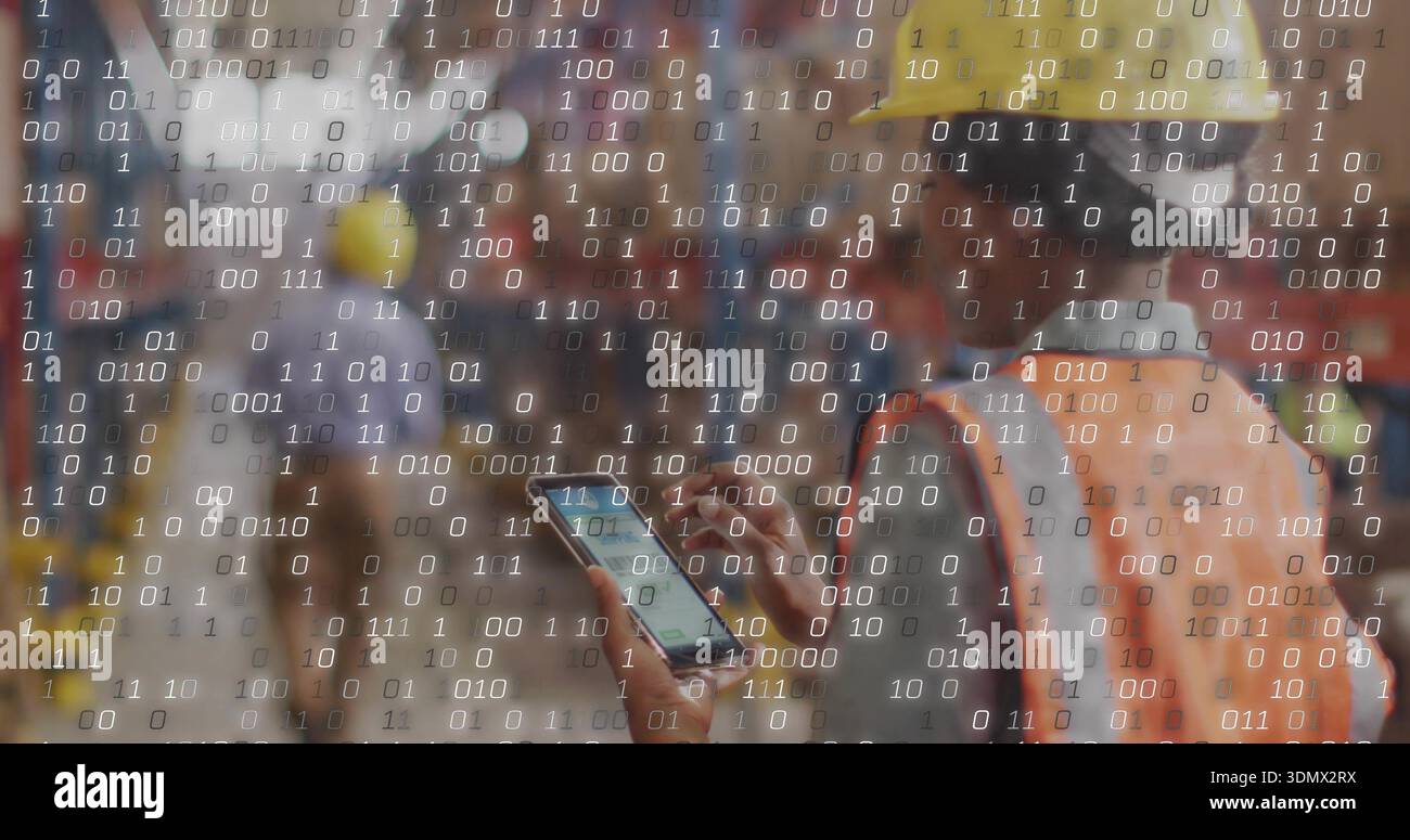 Using smartphone, worker in yellow hard hat, orange vest viewing binary digits at site, copy space Stock Photo