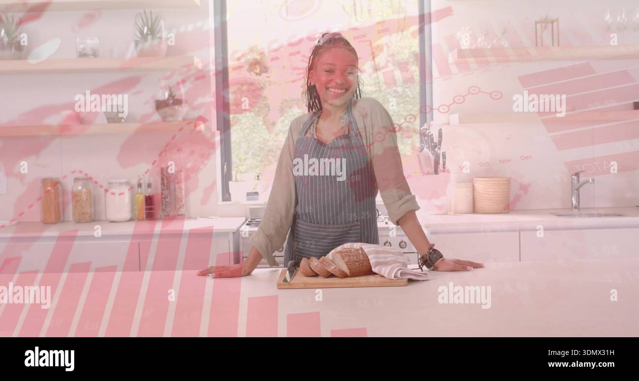 Smiling woman wearing striped apron slicing loaf on wooden cutting board in kitchen, chart overlay Stock Photo