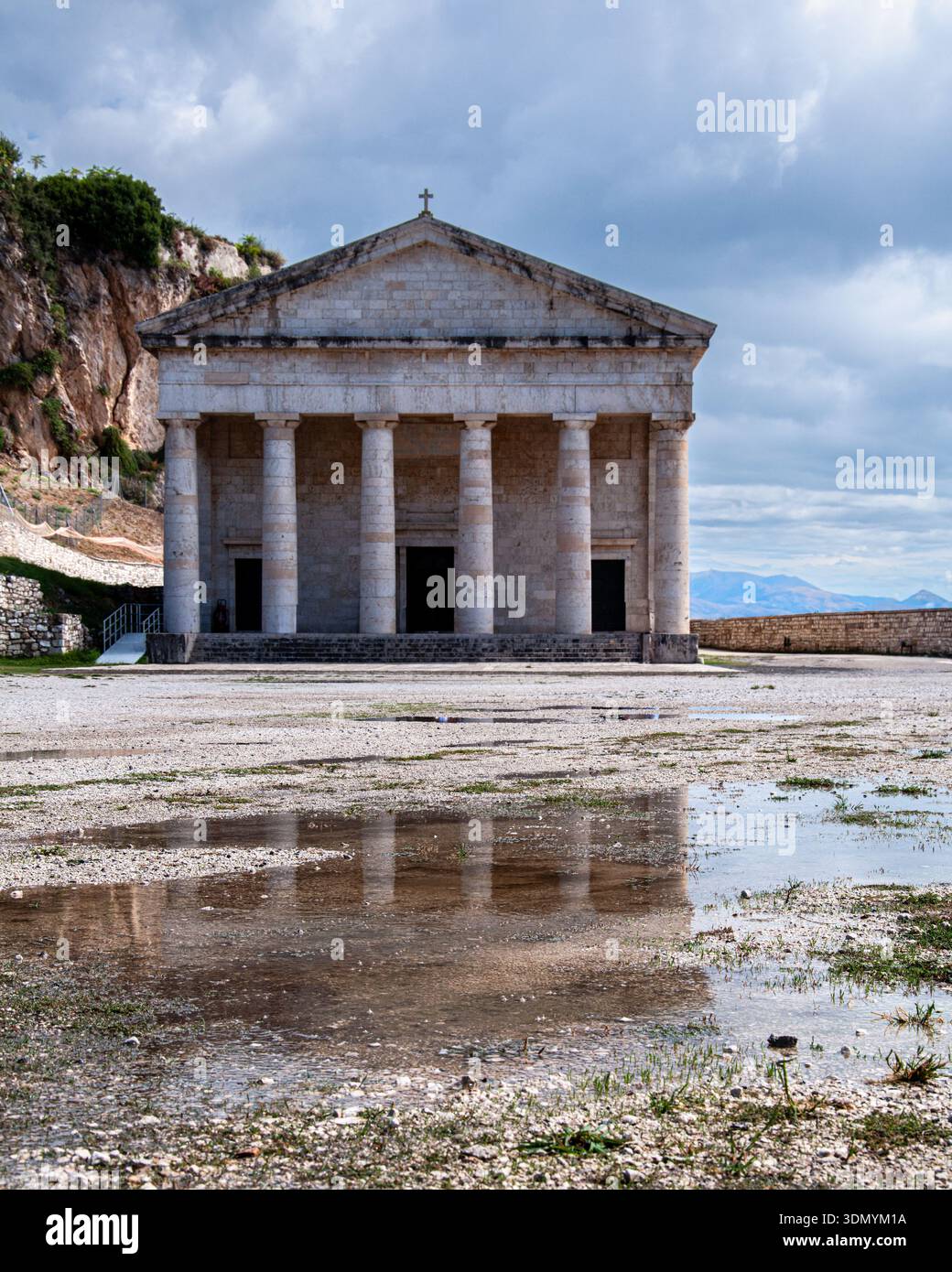 The Church of St George, within the Venetian Old  Fortress on the island of Corfu is reflected on the ground after recent rainfall Stock Photo