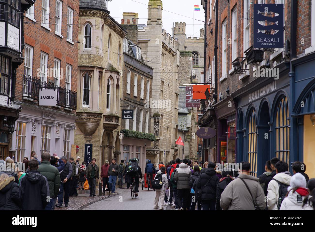 Busy historic street in Cambridge city centre with medieval buildings, timber frames and crowds of winter shoppers.Cambridge,England Stock Photo