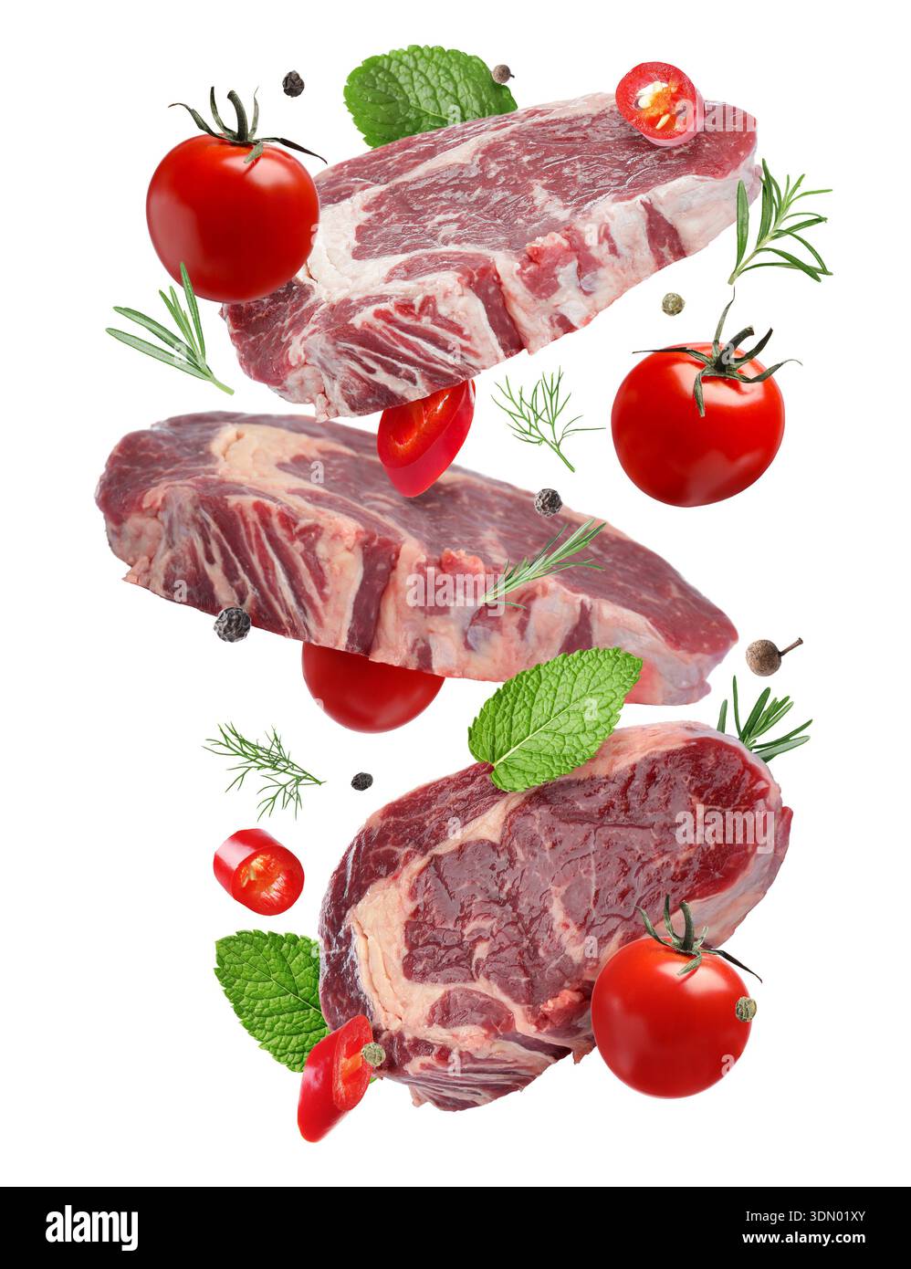 Fresh beef steaks falling on white background Stock Photo