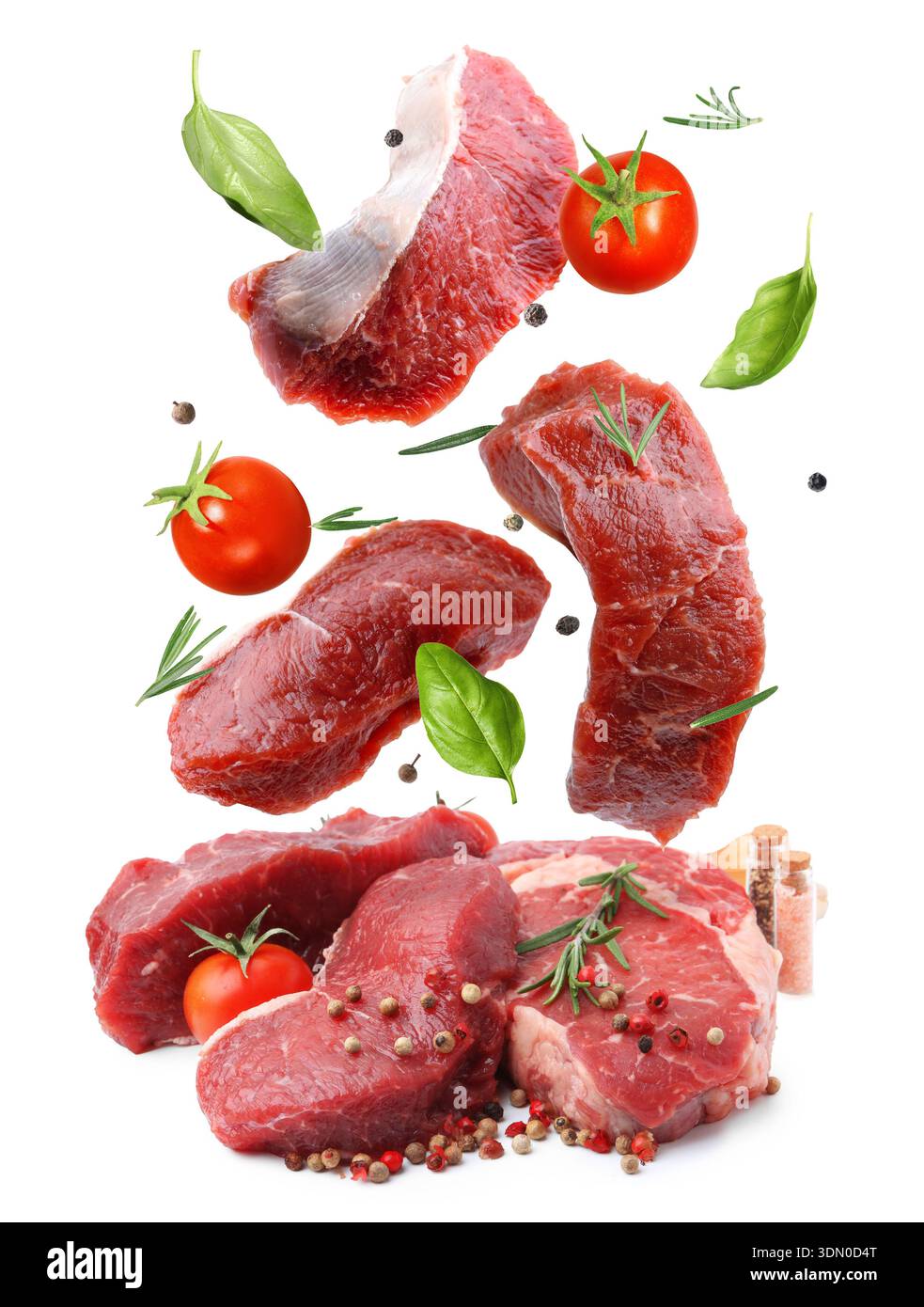 Fresh beef steaks falling on white background Stock Photo
