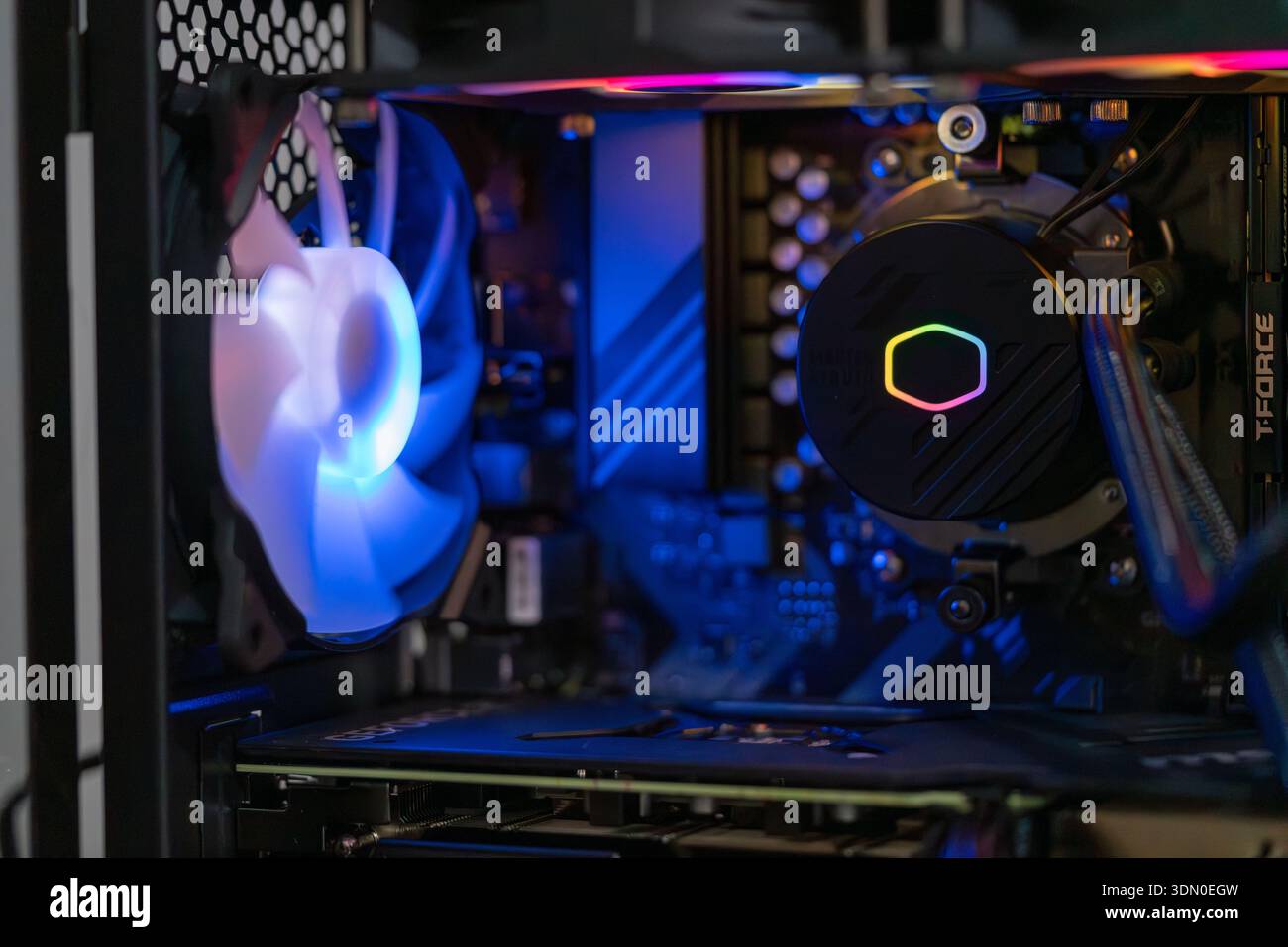 Gaming computer interior with RGB liquid cooling system and modern hardware components inside high performance desktop PC technology concept Stock Photo