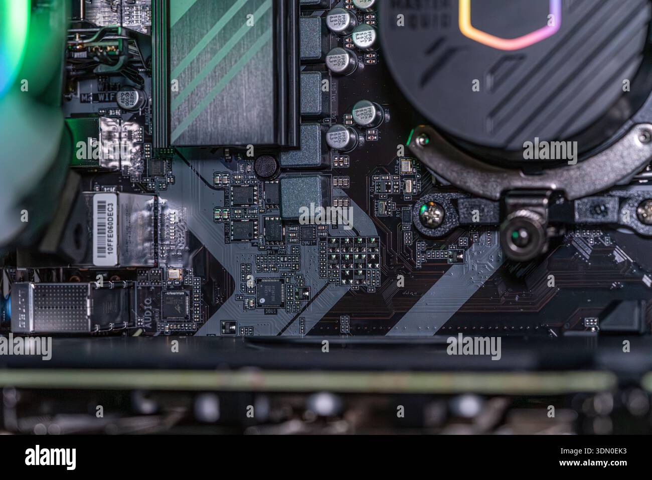 Gaming computer motherboard with RGB liquid cooling pump capacitors and ...