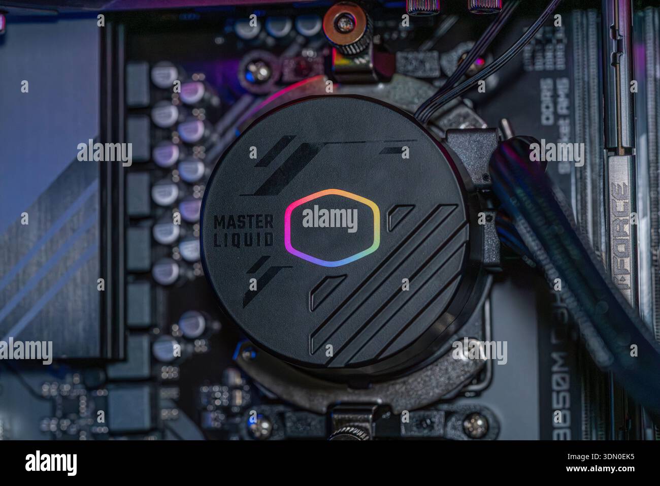 Gaming PC motherboard with RGB liquid cooling pump installed on processor inside modern high performance desktop computer technology Stock Photo