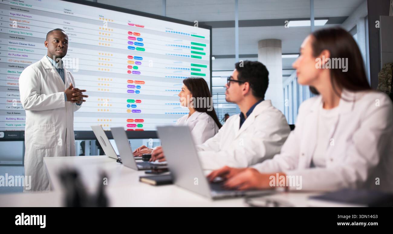 Meeting Of Diverse Medical Team In Hospital Office Discussing Code. Stock Photo