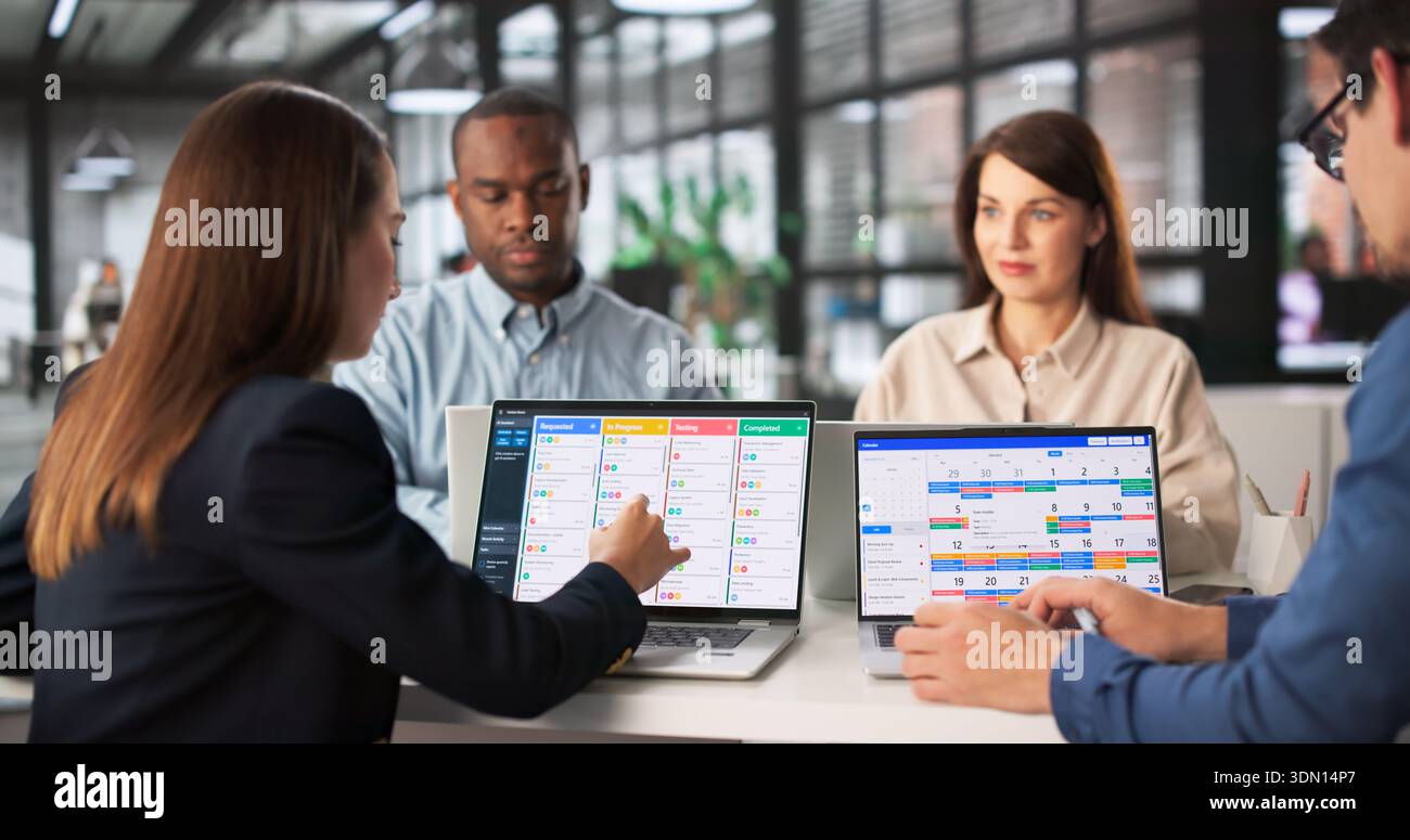 Multiracial Team Plans Schedule Using Kanban And Gantt Software. Stock Photo