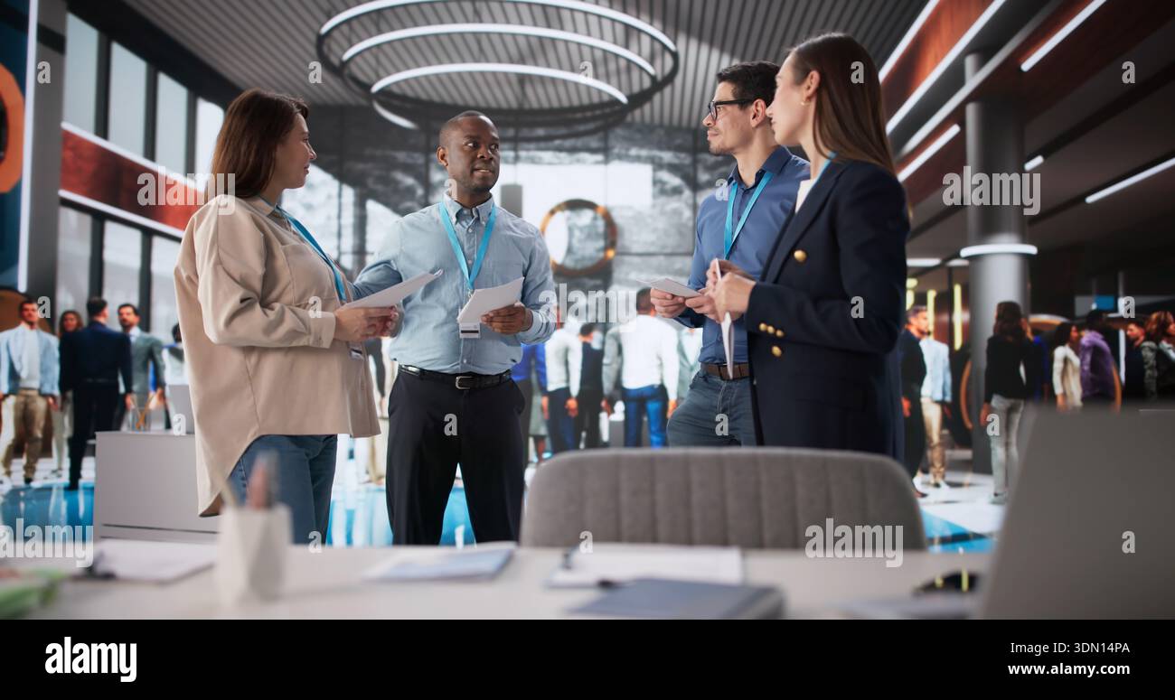 Successful Professionals Engaged In Productive Discussion At Business Conference Booth Stock Photo