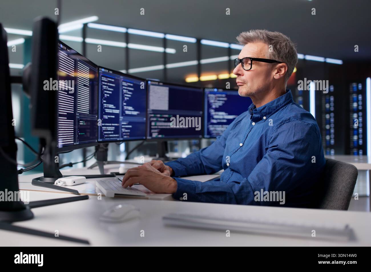 The Mature Programmer Is Developing Cyber Security Software For Businesses Stock Photo