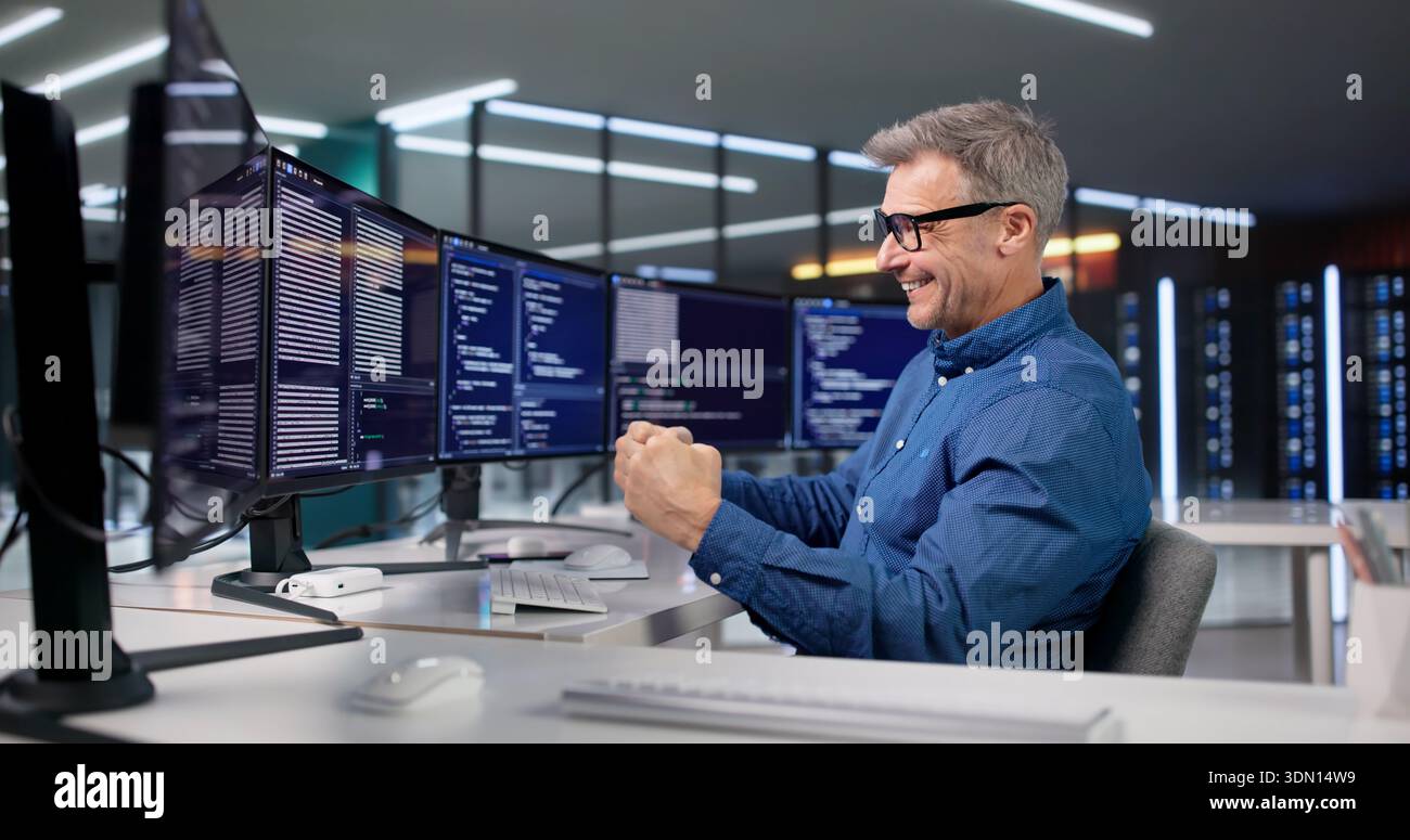 Excited Programmer Celebrates Win Optimizing Software Code In His Office. Stock Photo
