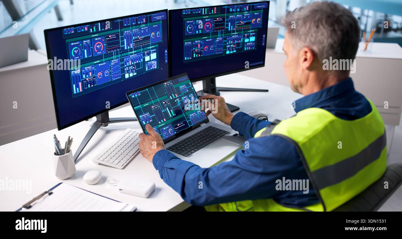Skilled Engineer Monitoring Electricity Generation In Smart Energy Plant Control Room Stock Photo