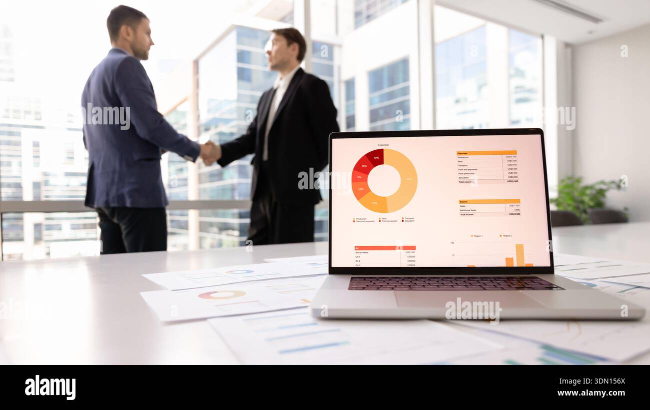 Close up laptop displaying financial analytics placed on table Stock Photo