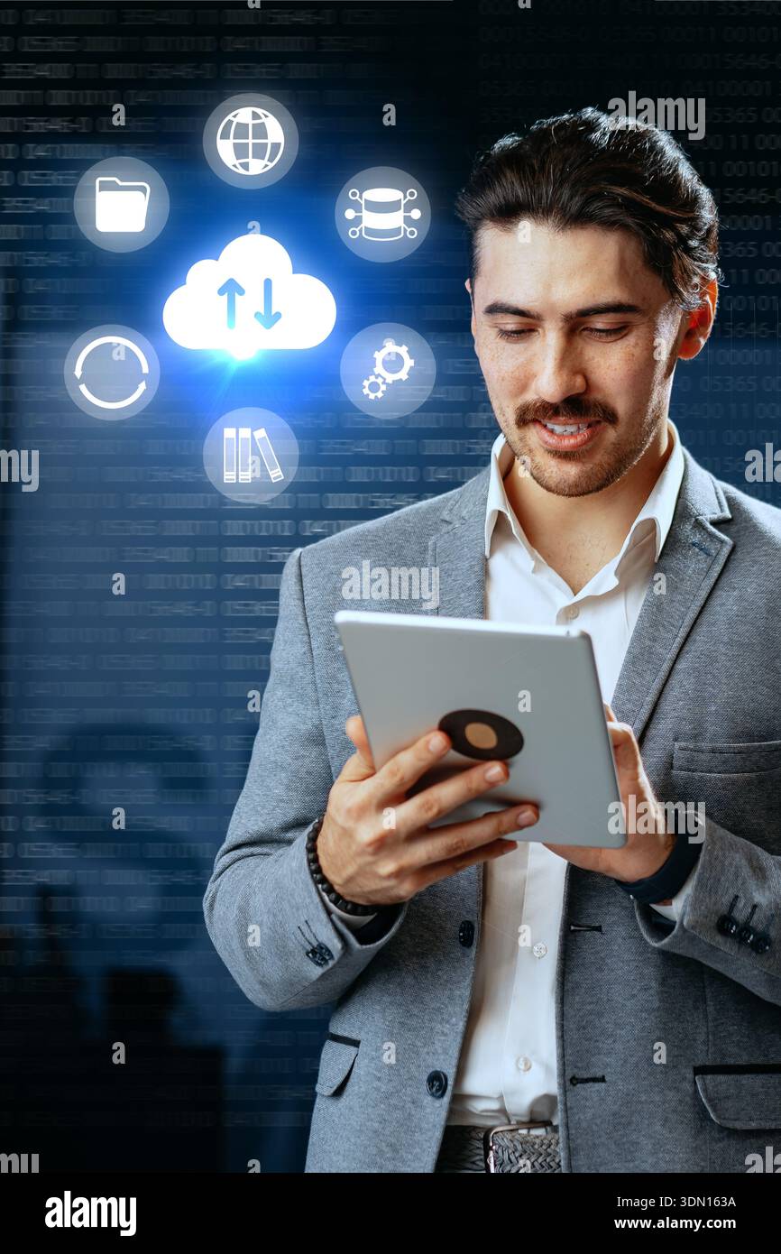 Businessman using tablet for cloud technology and data management in a modern office setup Stock Photo
