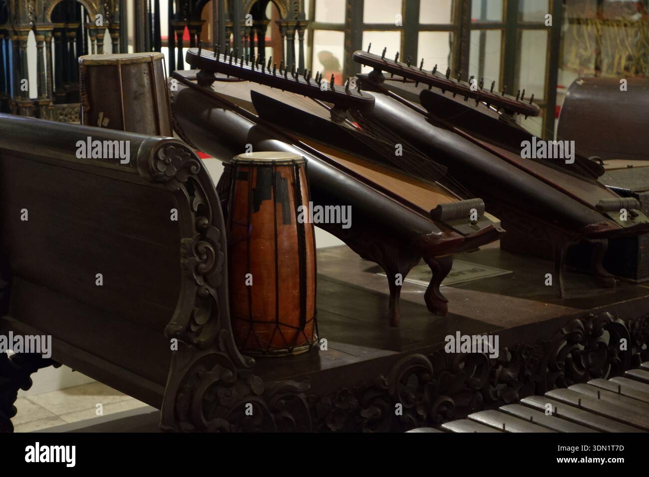Traditional Indonesian gamelan musical instruments displayed in a museum interior. Stock Photo