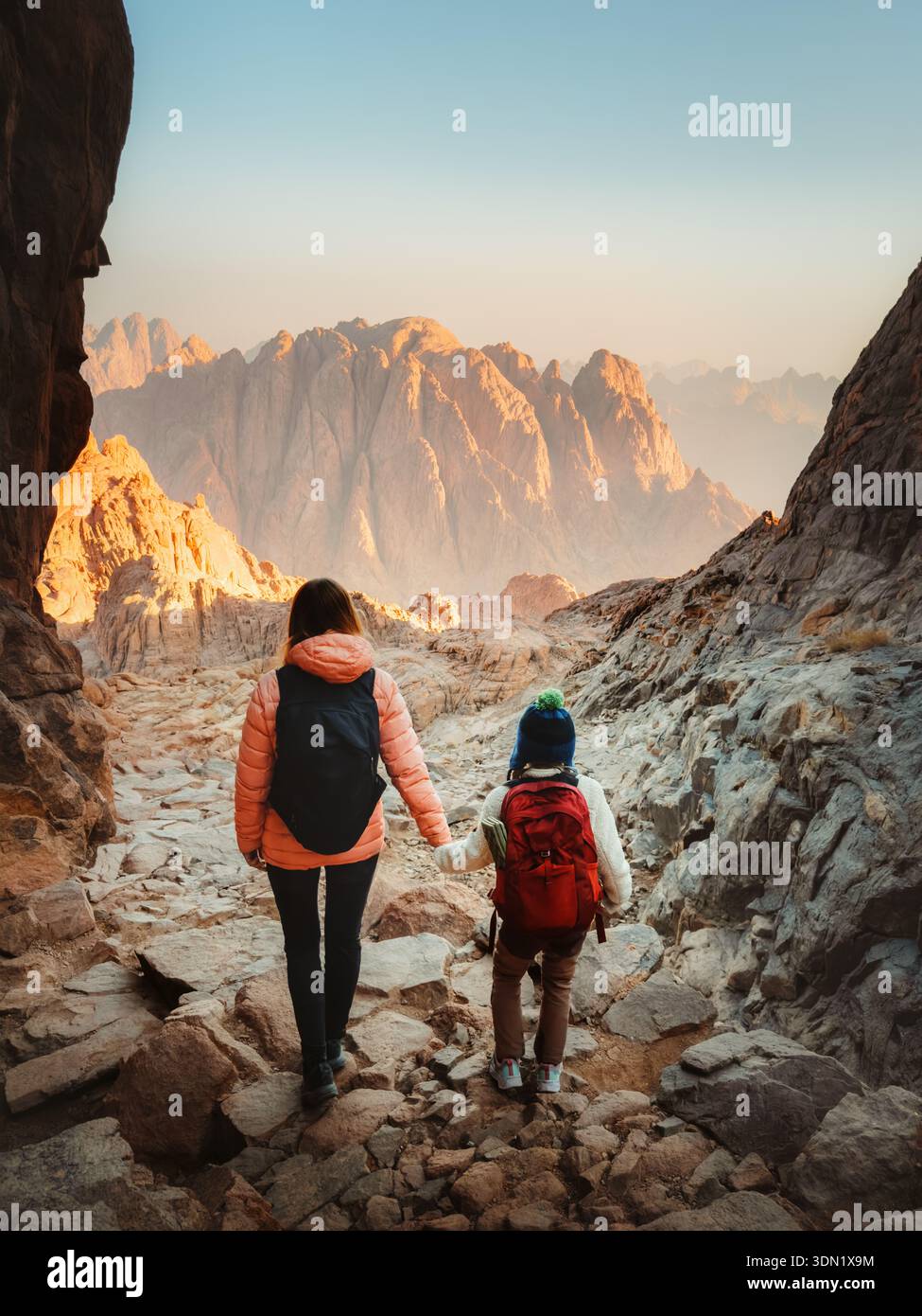 Family mother and child hiking in Egypt travel together enjoying Sinai mountains view, parent and kid globetrotters on active vacation trip healthy li Stock Photo