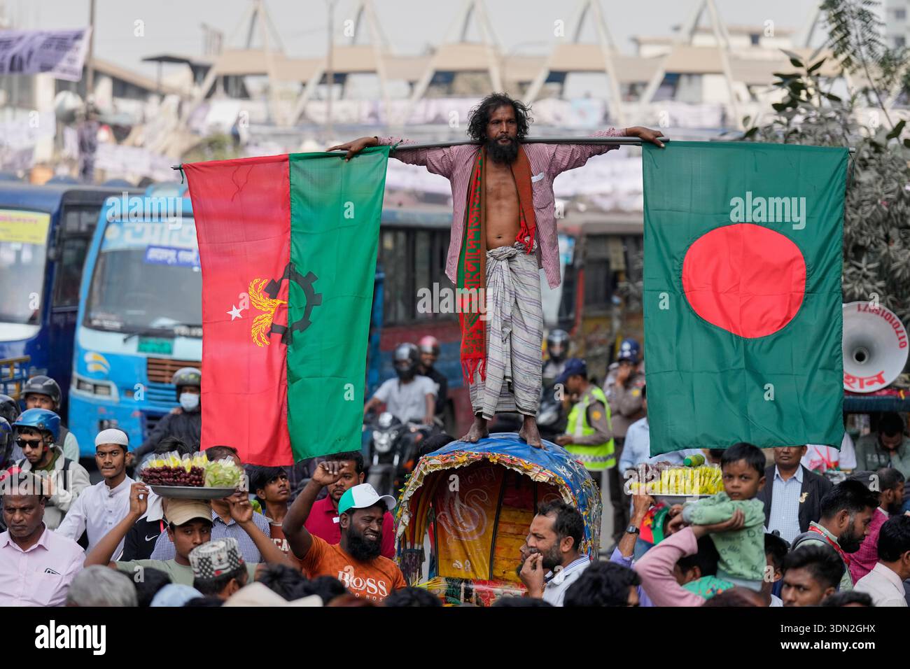 Zia Ricksha A supporter stands on a rickshaw as he holds a national flag of ...