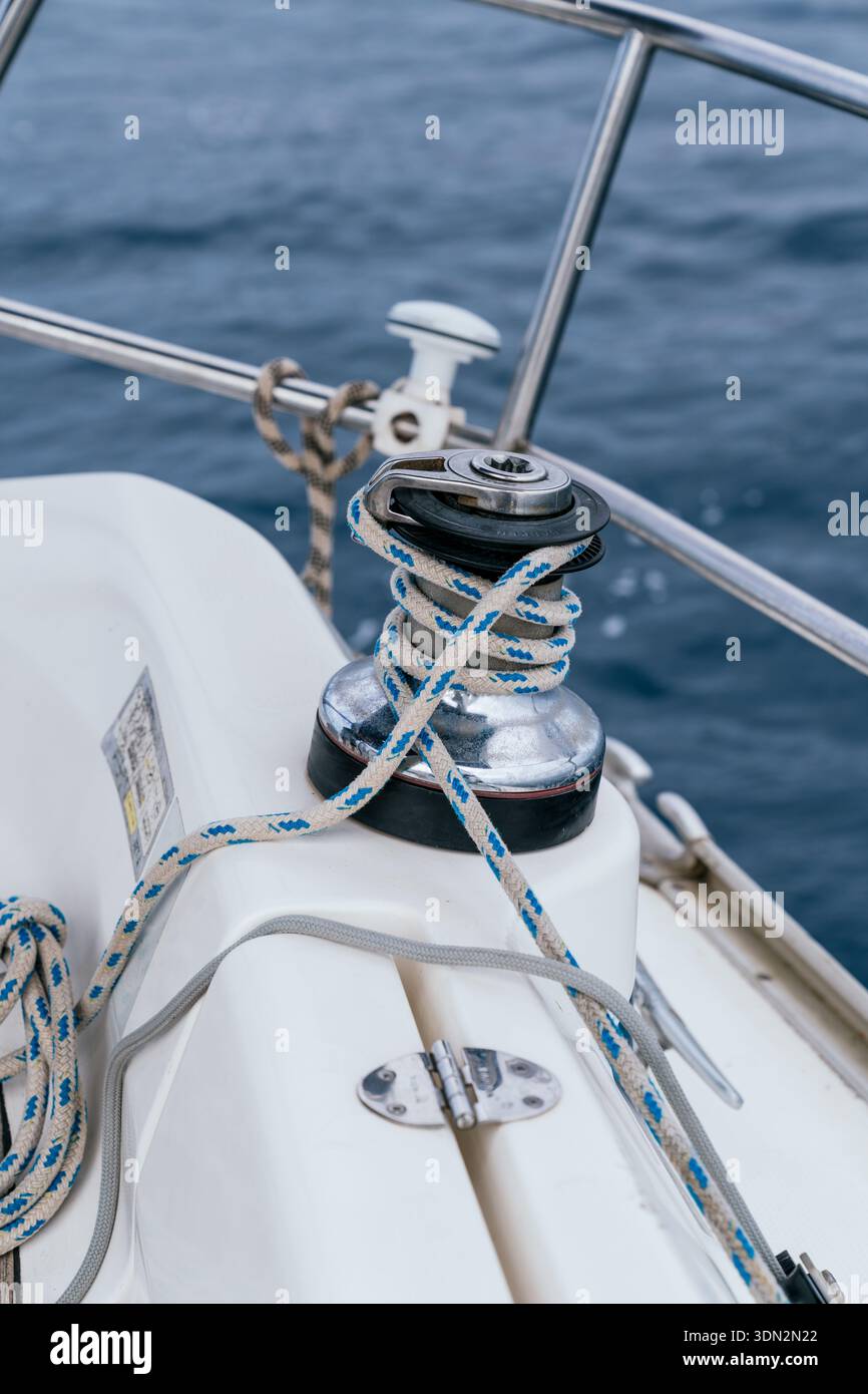 Sailing yacht winch with rope on deck Stock Photo