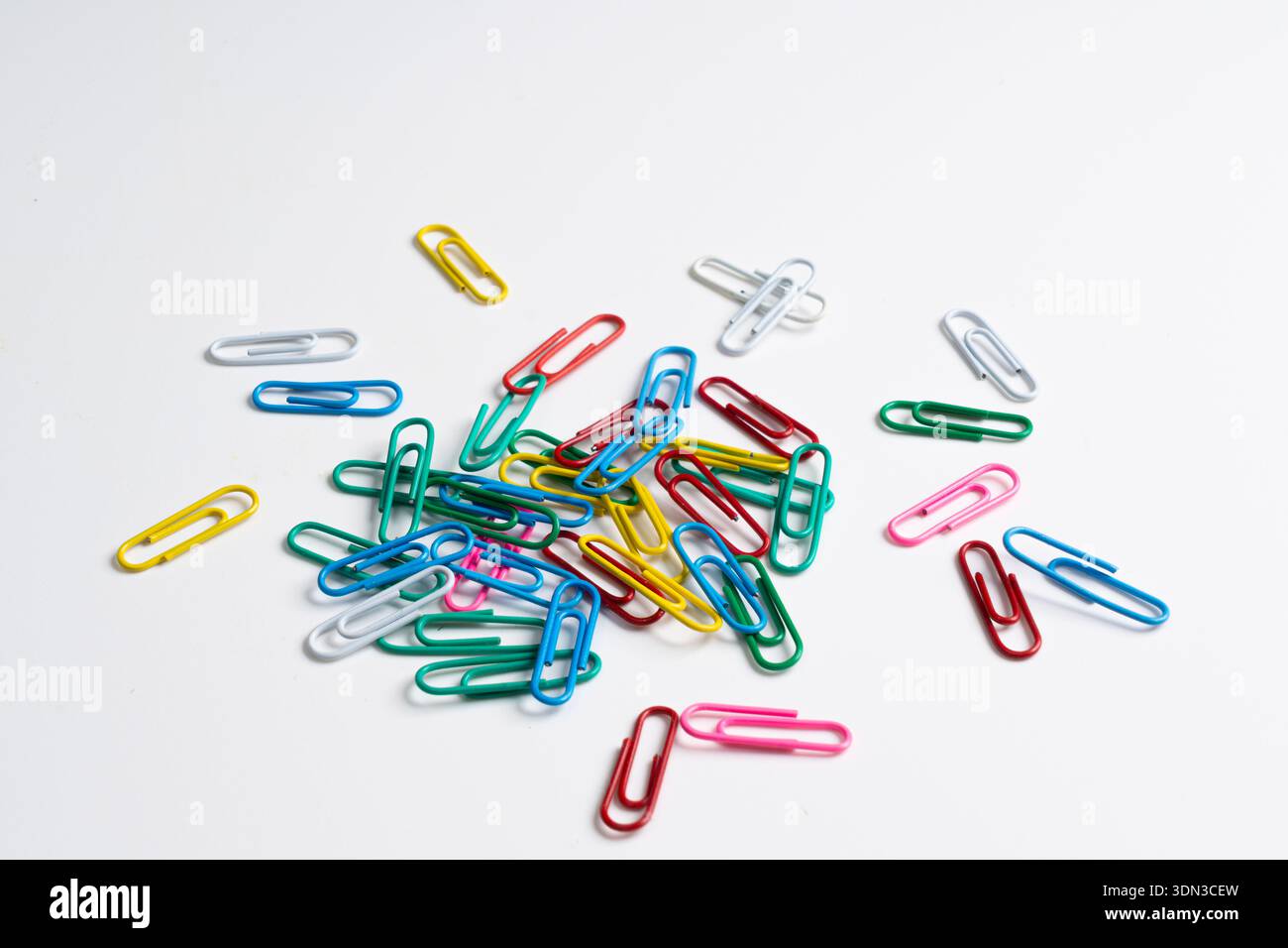colored paper clips on a white background Stock Photo